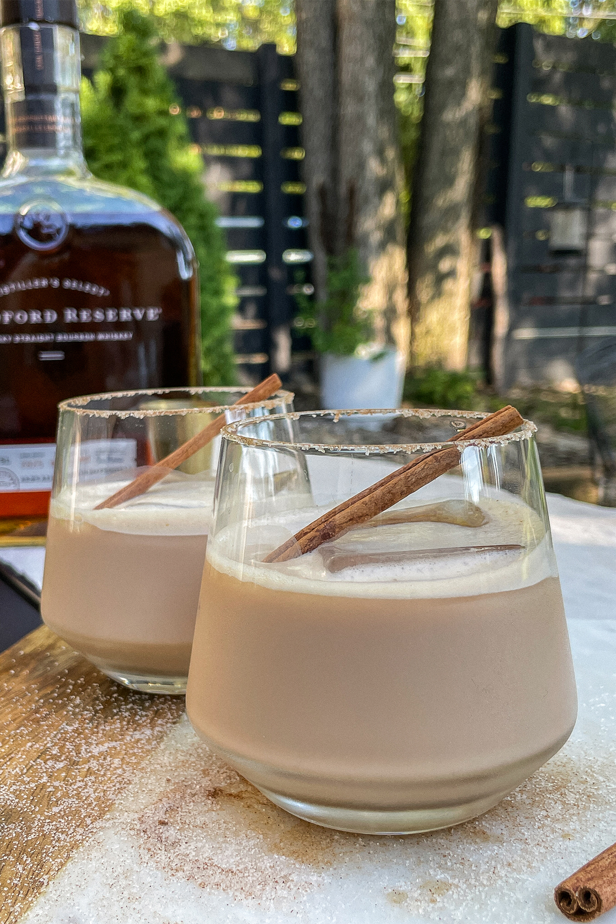 Iced Bourbon Chai cocktails topped with a cinnamon stick