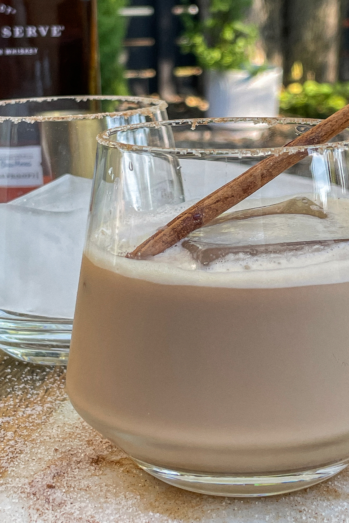 Iced Bourbon Chai cocktail topped with a cinnamon stick