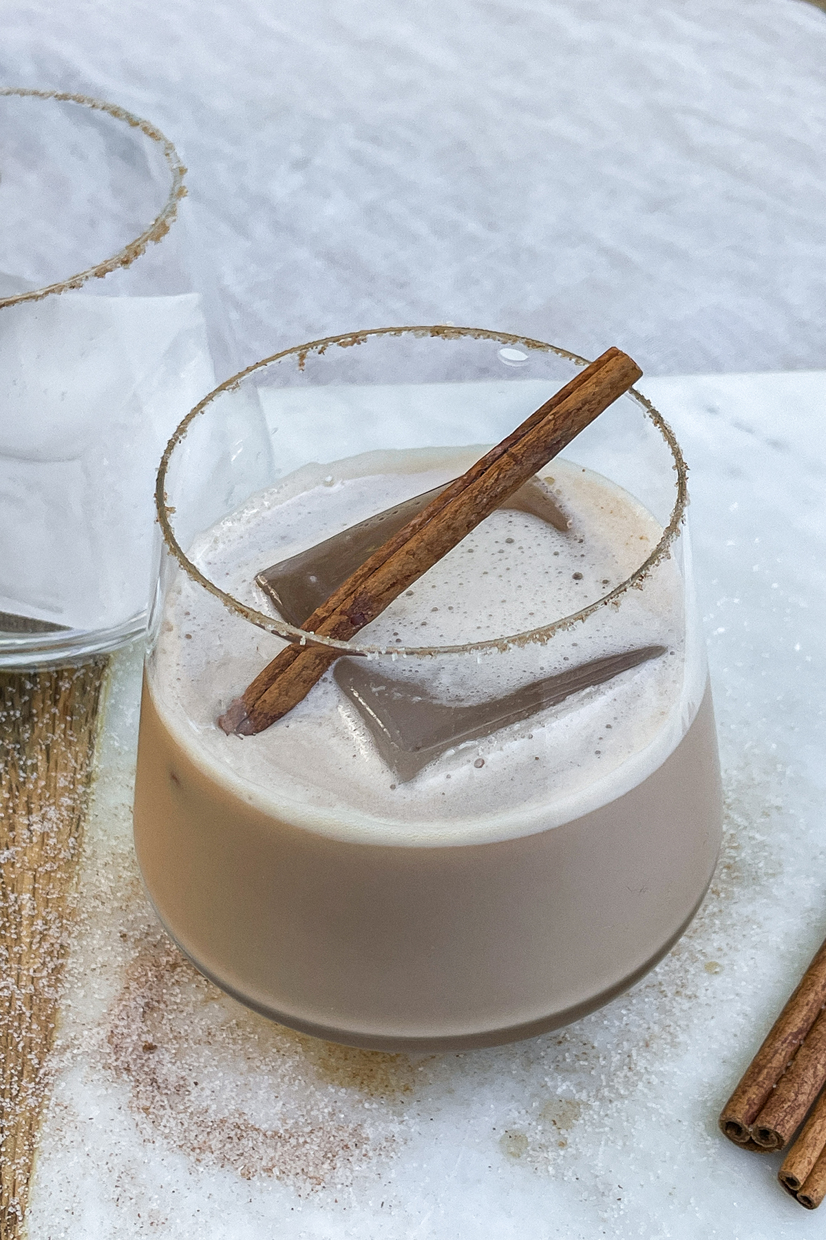 Iced Bourbon Chai cocktail topped with a cinnamon stick