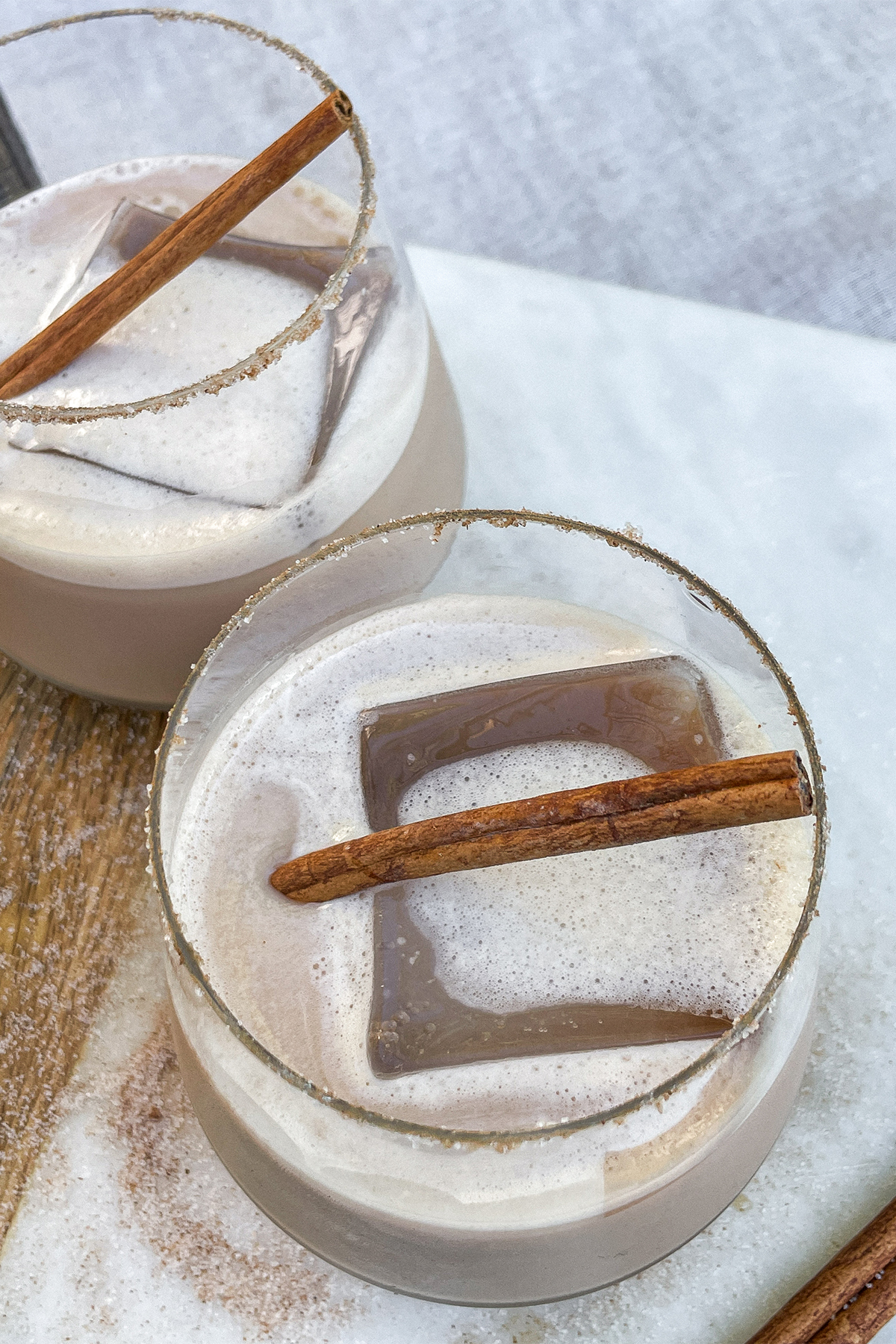 Iced Bourbon Chai cocktails topped with a cinnamon stick