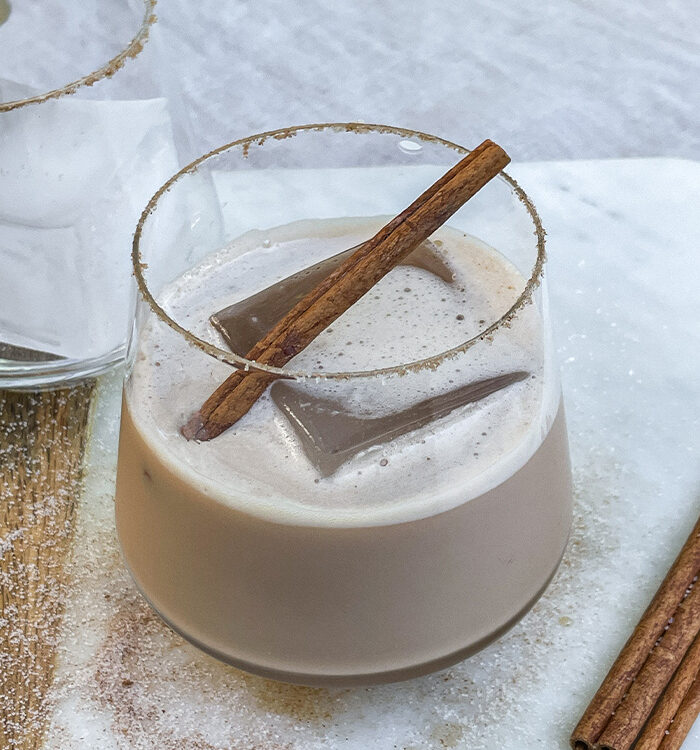 Iced Bourbon Chai cocktail garnished with a cinnamon stick