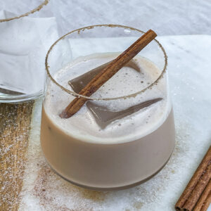 Iced Bourbon Chai cocktail garnished with a cinnamon stick