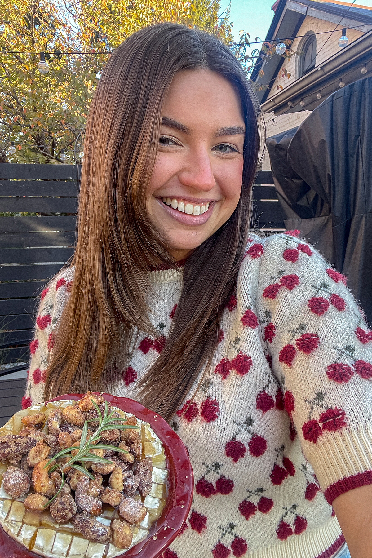 Tristen holding Brown Sugar Baked Brie With Candied Nuts in a pie pan