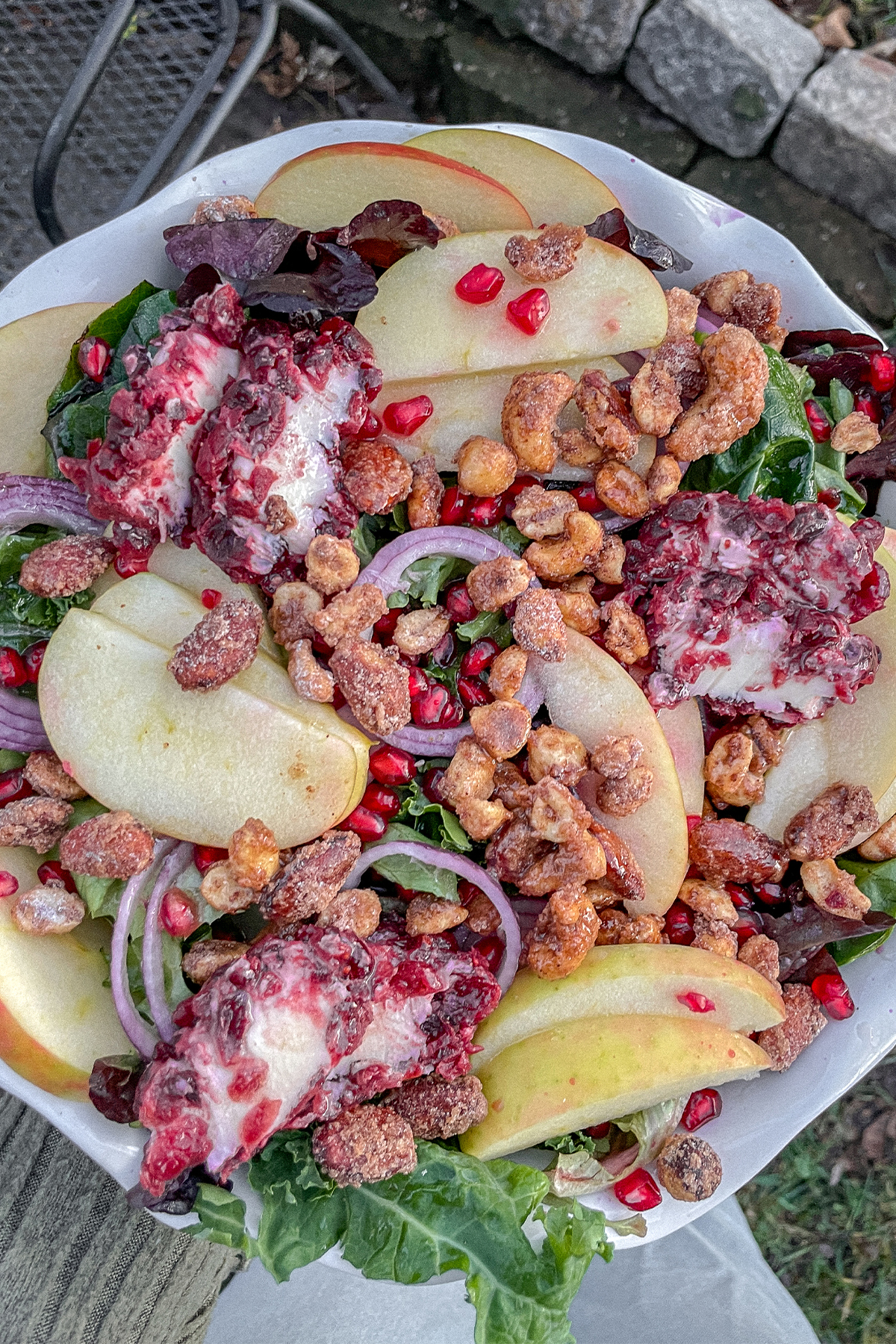 Kale Apple Salad With Cranberry Goat Cheese served in a white ruffle pie dish