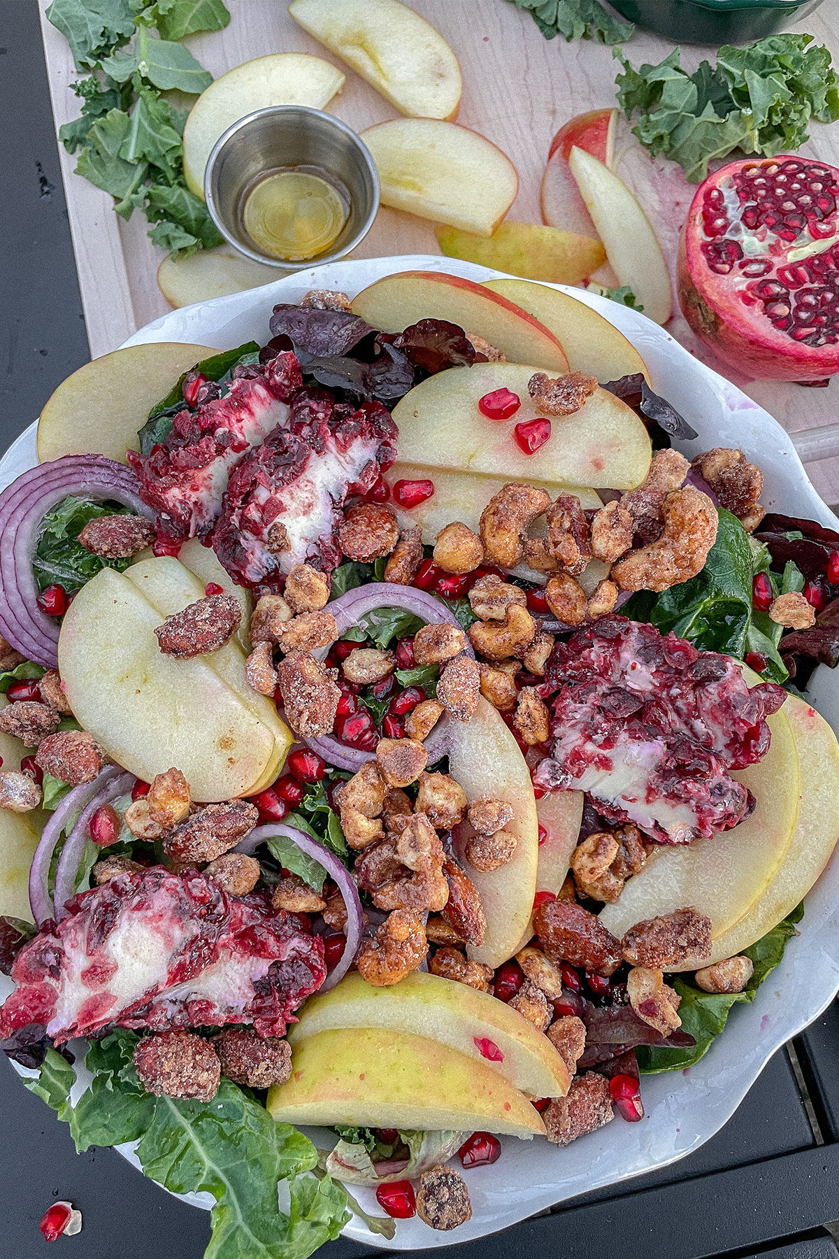 Kale Apple Salad With Cranberry Goat Cheese served in a white ruffle pie dish