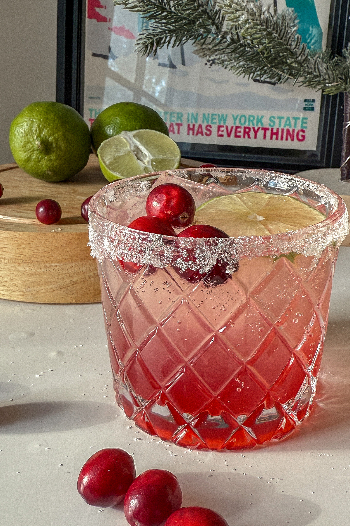 Cranberry Moscow Mule in a glass garnished with sugar, lime and fresh cranberries