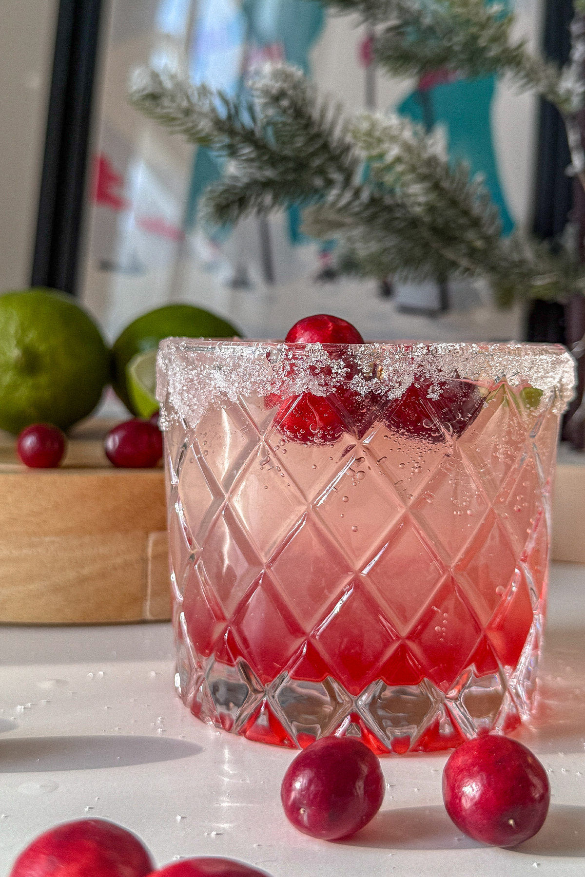 Cranberry Moscow Mule in a glass garnished with sugar, lime and fresh cranberries